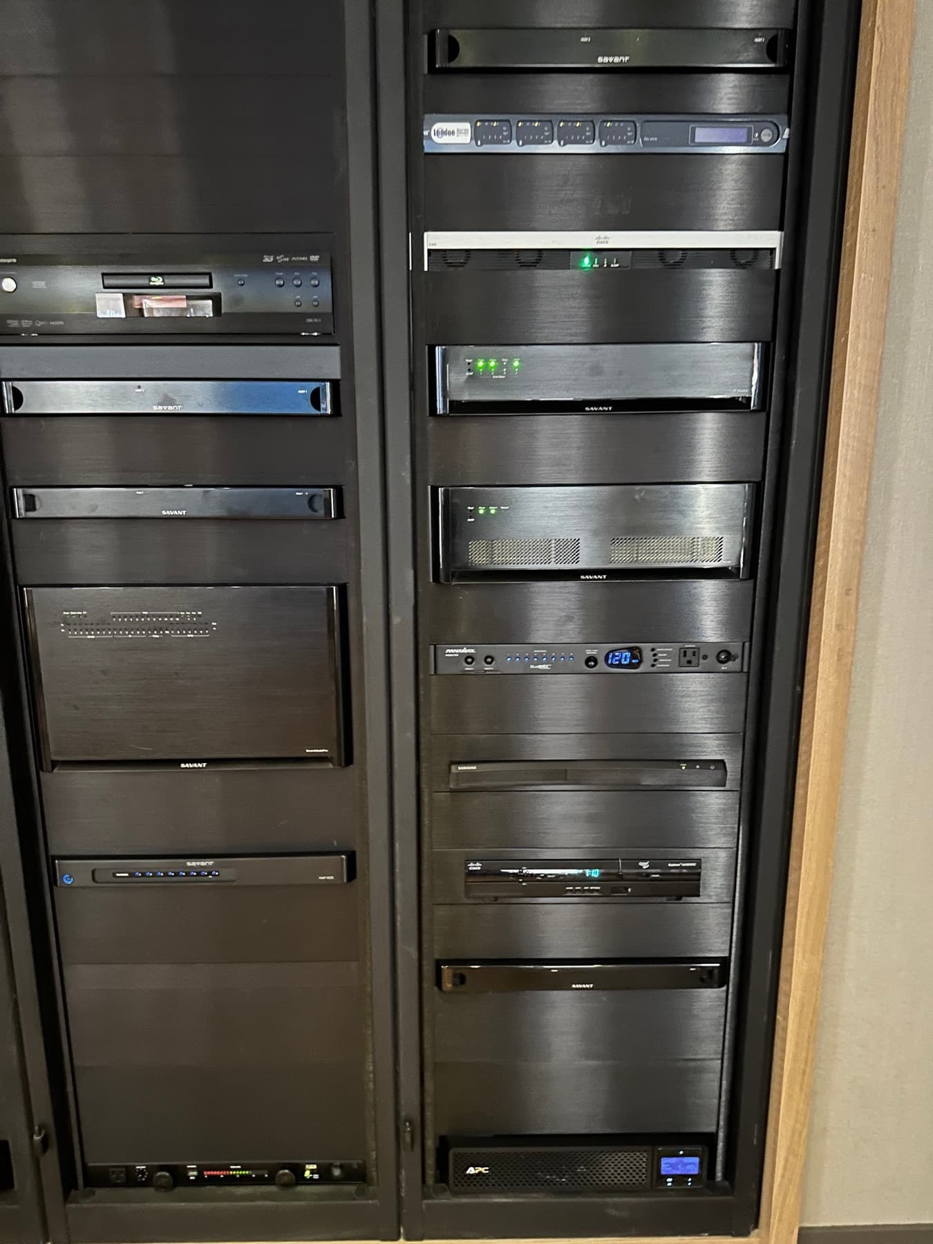 Two equipment racks of amplifiers and AV components, installed and powered